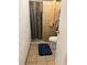 Small bathroom featuring a shower stall with a patterned curtain, tiled walls, and a toilet at 6206 Paul Buchman Hwy, Plant City, FL 33565