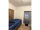 Modest bedroom featuring tile floors and a window with patterned curtains at 6206 Paul Buchman Hwy, Plant City, FL 33565