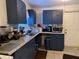 Kitchen area with blue cabinets, a sink, and countertop appliances at 6206 Paul Buchman Hwy, Plant City, FL 33565