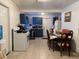 Open kitchen and dining area featuring a white refrigerator and stove adjacent to a long dining table at 6206 Paul Buchman Hwy, Plant City, FL 33565