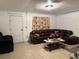 Living room area offering tile floors, a brown sectional sofa, and a glass coffee table at 6206 Paul Buchman Hwy, Plant City, FL 33565