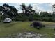 Sprawling property with car, trailer, and various plants at 6206 Paul Buchman Hwy, Plant City, FL 33565
