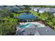Overhead view featuring a community pool and pond surrounded by well-maintained homes and lush greenery at 6304 Parkside Meadow Dr, Tampa, FL 33625