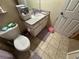 Functional bathroom with a toilet, vanity, and tile flooring at 6304 Parkside Meadow Dr, Tampa, FL 33625