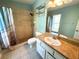 Primary bathroom featuring vanity, toilet, and tiled walk-in shower with curtain at 6304 Parkside Meadow Dr, Tampa, FL 33625