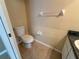 The home's half-bathroom features a toilet, towel rack, and vanity at 6304 Parkside Meadow Dr, Tampa, FL 33625