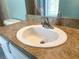 Close-up of a bathroom sink with a chrome faucet and faux-marble countertop at 6304 Parkside Meadow Dr, Tampa, FL 33625