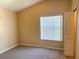 Bedroom with a window allowing for natural light and carpeted floor at 6304 Parkside Meadow Dr, Tampa, FL 33625