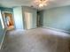 Spacious bedroom with wall-to-wall carpet and an attached bathroom for convenience at 6304 Parkside Meadow Dr, Tampa, FL 33625
