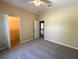 Bedroom with neutral-toned walls, carpet, and access to a walk-in closet at 6304 Parkside Meadow Dr, Tampa, FL 33625