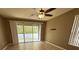 Bedroom with ceiling fan, tile floors, and sliding doors that lead to outdoor patio at 6304 Parkside Meadow Dr, Tampa, FL 33625