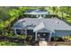 Aerial shot of the community clubhouse, with a view of pond and pool, surrounded by lush landscaping at 6304 Parkside Meadow Dr, Tampa, FL 33625
