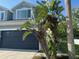 Two-story home with a two car garage, palm trees and large window at 6304 Parkside Meadow Dr, Tampa, FL 33625