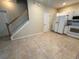 Open-concept kitchen featuring white cabinets, appliances, and a spacious tile floor at 6304 Parkside Meadow Dr, Tampa, FL 33625