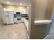 Bright kitchen with white cabinetry, appliances, tile floor and plenty of counter space at 6304 Parkside Meadow Dr, Tampa, FL 33625