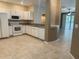 Well-lit kitchen boasts white appliances, tile flooring, and seamless flow into living area at 6304 Parkside Meadow Dr, Tampa, FL 33625