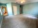Large primary bedroom with carpet flooring, ceiling fan, and attached bathroom at 6304 Parkside Meadow Dr, Tampa, FL 33625