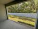 Spacious covered patio and backyard with green lawn at 6304 Parkside Meadow Dr, Tampa, FL 33625