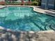 View of community pool with steps and railings, featuring a refreshing space for recreation at 6304 Parkside Meadow Dr, Tampa, FL 33625