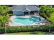 Aerial view of sparkling community pool, surrounded by lounge chairs and tropical landscaping near the clubhouse at 6304 Parkside Meadow Dr, Tampa, FL 33625