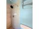 Primary bathroom with tiled walk-in shower, rainfall showerhead, and grab bar at 6304 Parkside Meadow Dr, Tampa, FL 33625