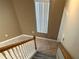 Staircase with tiled landing, wood railing, and carpet on the stairs at 6304 Parkside Meadow Dr, Tampa, FL 33625