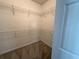 Well-organized walk-in closet with shelves and carpeting for optimal storage and convenience at 6304 Parkside Meadow Dr, Tampa, FL 33625