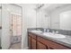 Bathroom featuring a double sink vanity with granite countertop and a shower/tub combo with themed curtain at 6708 Hazelnut Spice Dr, Ruskin, FL 33573
