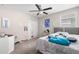 Bright bedroom with a ceiling fan, neutral walls, and closet for storage; decorated with art and personal touches at 6708 Hazelnut Spice Dr, Ruskin, FL 33573