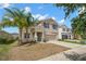 Charming two-story home with palm trees in the front yard and a stucco exterior at 6708 Hazelnut Spice Dr, Ruskin, FL 33573