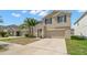 Two-story home with a two-car garage and a well-manicured front yard and a sidewalk out front at 6708 Hazelnut Spice Dr, Ruskin, FL 33573