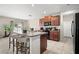 An open concept kitchen featuring granite countertops and bar seating at 6708 Hazelnut Spice Dr, Ruskin, FL 33573