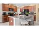 Kitchen island with seating and granite counters, perfect for entertaining guests at 6708 Hazelnut Spice Dr, Ruskin, FL 33573