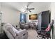 Cozy living room with recliner seating, a large TV, and a ceiling fan at 6708 Hazelnut Spice Dr, Ruskin, FL 33573