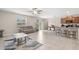 Spacious living room featuring tile floors, neutral colors, and a ceiling fan at 6708 Hazelnut Spice Dr, Ruskin, FL 33573