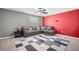 Comfortable living room with a large sectional couch, gray walls, and a colorful accent wall; great space for entertaining at 6708 Hazelnut Spice Dr, Ruskin, FL 33573