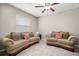 Cozy sitting room with a pair of loveseats. Neutral color, with tile floors and a ceiling fan at 6708 Hazelnut Spice Dr, Ruskin, FL 33573