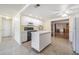 Open-concept kitchen with center island, stainless steel appliances, and a view into the living room at 6894 82Nd N Ave, Pinellas Park, FL 33781