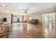 Spacious living room with wood floors, a stone fireplace, and sliding glass doors to the backyard at 6894 82Nd N Ave, Pinellas Park, FL 33781