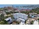 An elevated view of the white condo building, with nearby buildings and the St. Petersburg harbor in the background at 700 Beach Ne Dr # 803, St Petersburg, FL 33701