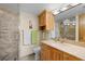 Well-lit bathroom featuring a marble vanity, wooden cabinets, glass shower, and modern fixtures for a spa-like experience at 700 Beach Ne Dr # 803, St Petersburg, FL 33701