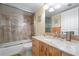 Modern bathroom with a tile shower, marble countertop, and wooden vanity combines style and functionality for daily comfort at 700 Beach Ne Dr # 803, St Petersburg, FL 33701