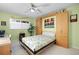 Bedroom featuring a Murphy bed, ceiling fan, and green walls offers a flexible and stylish space-saving design at 700 Beach Ne Dr # 803, St Petersburg, FL 33701