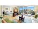 Comfortable living room with hardwood floors, open view to the primary bedroom, balcony, and stylish decor at 700 Beach Ne Dr # 803, St Petersburg, FL 33701
