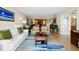 Open living room with bright decor, wood floors, and access to kitchen area provides an inviting living space at 700 Beach Ne Dr # 803, St Petersburg, FL 33701