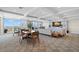 Open-concept living room with comfortable seating, elegant decor, and large windows at 700 Beach Ne Dr # 803, St Petersburg, FL 33701
