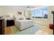 Bright main bedroom with hardwood floors, a ceiling fan and large windows that offer beautiful views of the area at 700 Beach Ne Dr # 803, St Petersburg, FL 33701