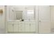 Bright bathroom with marble countertops, dual sinks, and modern white cabinetry at 7525 E 116Th St, Palmetto, FL 34221