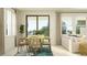 Bright dining room featuring a wood table, wicker chairs, and sliding glass doors to a backyard view at 7525 E 116Th St, Palmetto, FL 34221