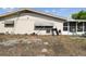 Backyard exterior showing partial lawn and exterior of enclosed patio at 8907 Pandora Ln, Port Richey, FL 34668